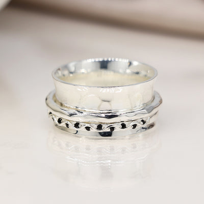 Earth and Elements Jewellery
https://www.earthandelements.co.uk › products › sterling-silver-spinning-ring-black-crystal-wave-band