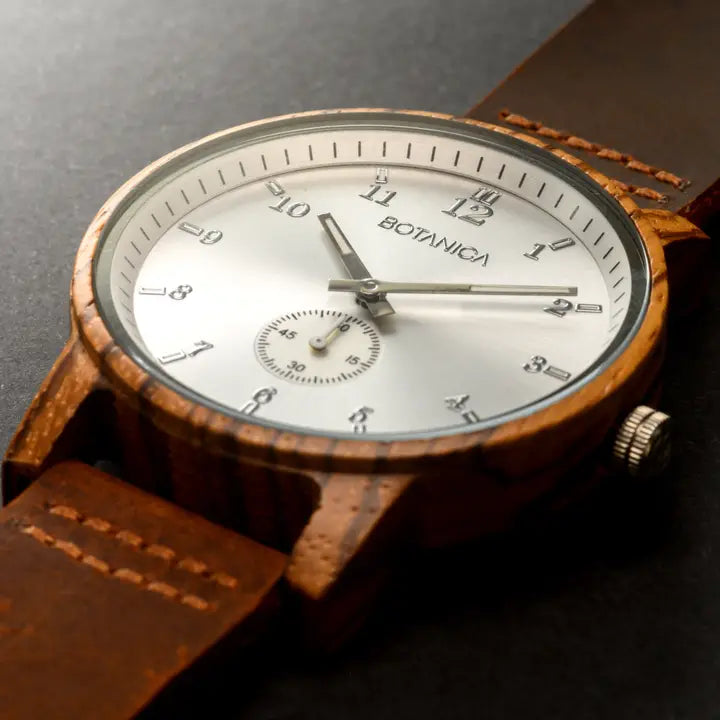 Wooden watch with a brown leather strap on a dark background