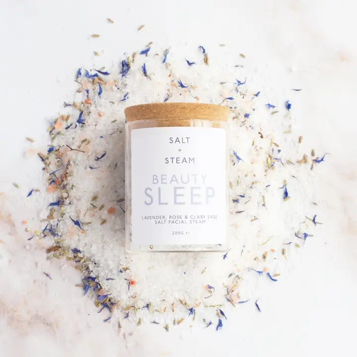 Salt and Steam Beauty Sleep salt facial scrub with a wooden lid on a white background