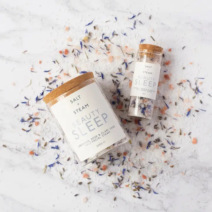 Two 'Beau Sleep' products on a textured surface with colorful elements