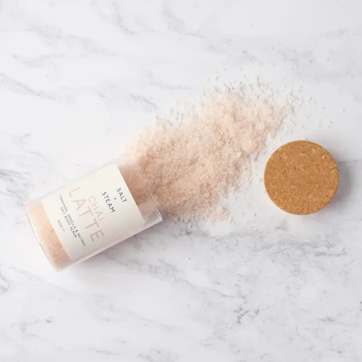 Bath salt packaging with a cork lid on a marble surface