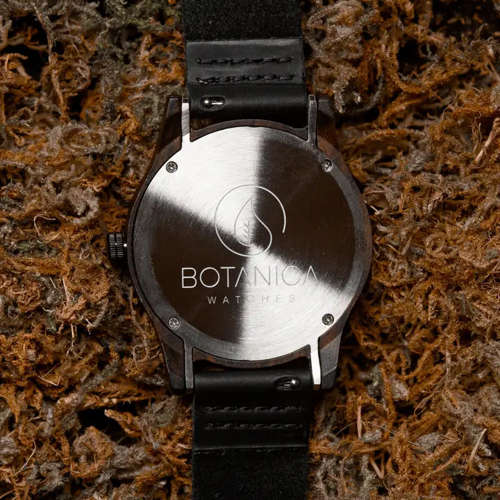 Watch with 'Botanica Watches' logo on a textured brown background