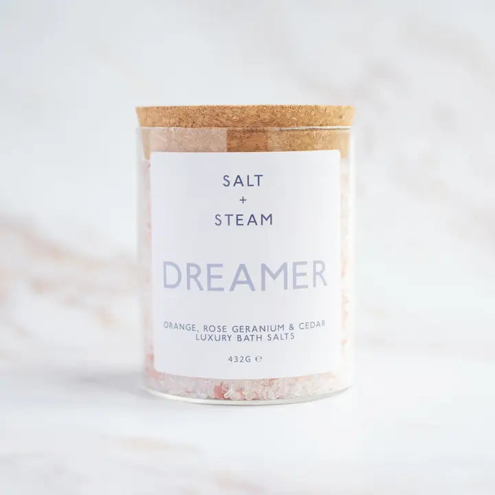 Bath salts container labeled 'Dreamer' by Salt + Steam on a light background
