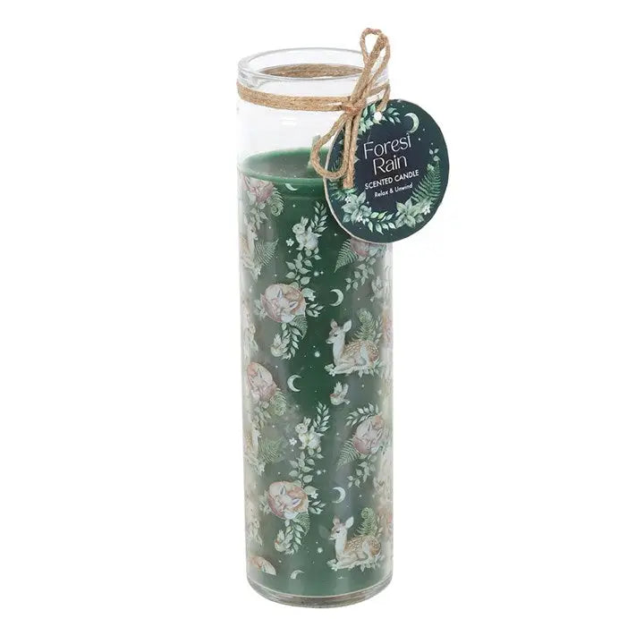 Decorative candle with forest-themed design and label on a white background