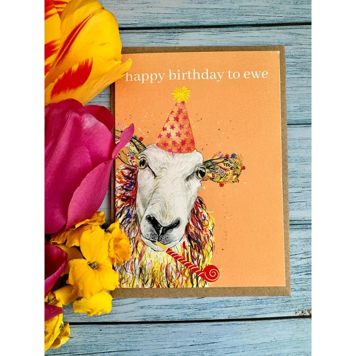 Birthday card with a sheep illustration and flowers on a wooden surface eco friendly