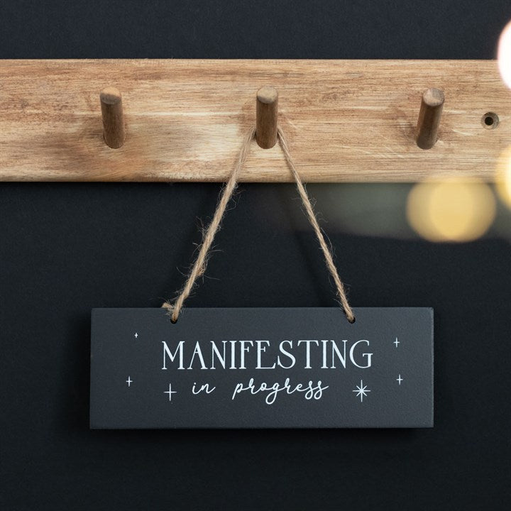 MANIFESTING IN PROGRESS HANGING SIGN