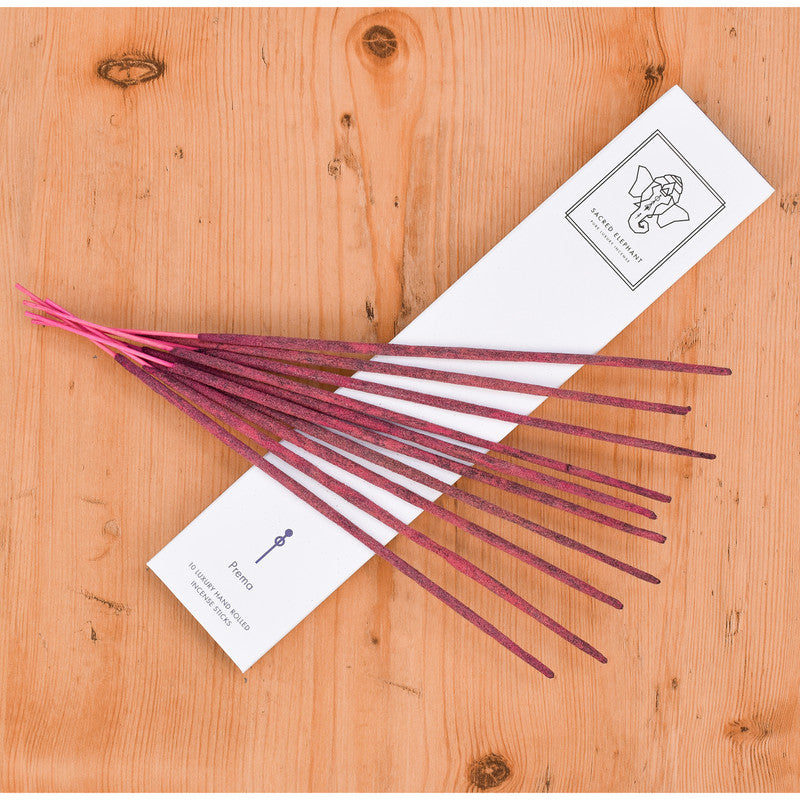 Purple incense sticks with white labels on a wooden surface