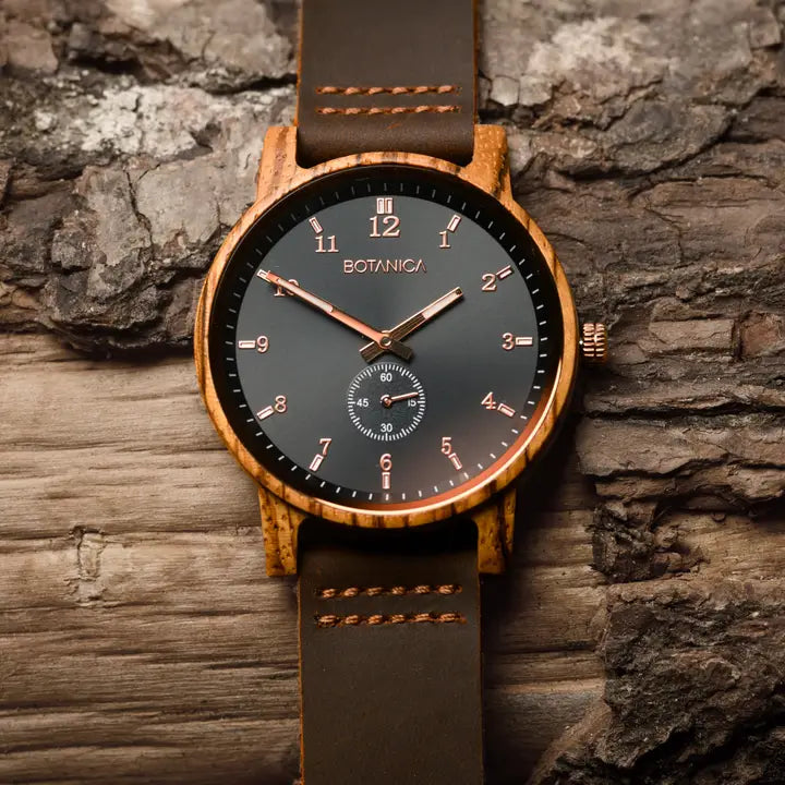 Wooden watch with brown leather strap on a stone background