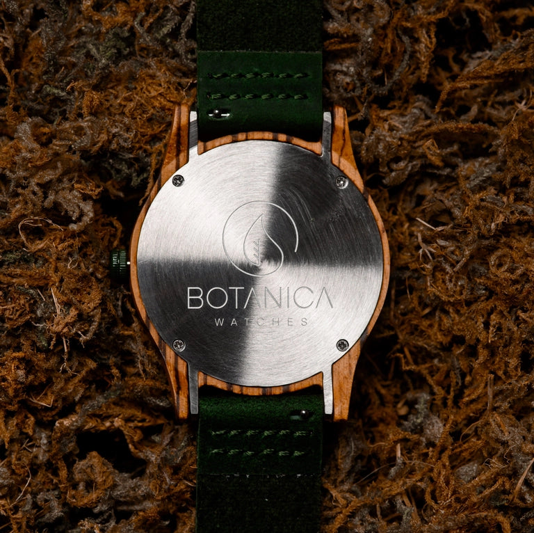 Watch with wooden case and green strap on a textured brown background
